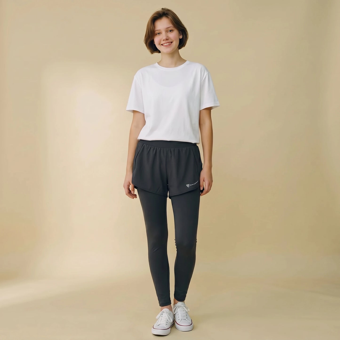 Woman in 2-in-1 high-waist leggings with built-in overlay shorts, full-length yoga pants, front view