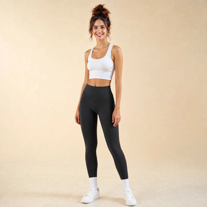 Woman in black high-waist seamless leggings, full-length yoga pants, front view